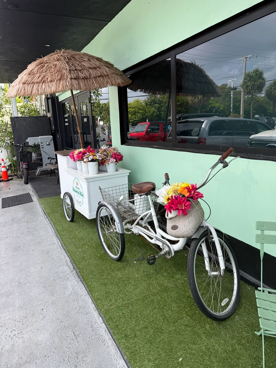 A bicycle with a flower cart outside Croissants de France on Stock Island