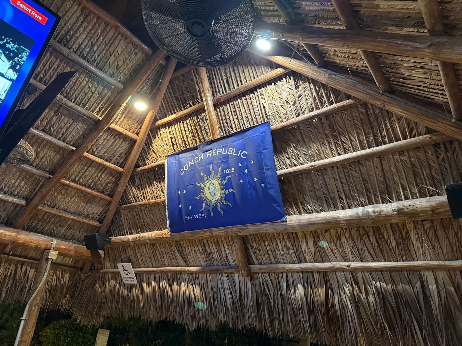Conch Republic flag under a thatched roof